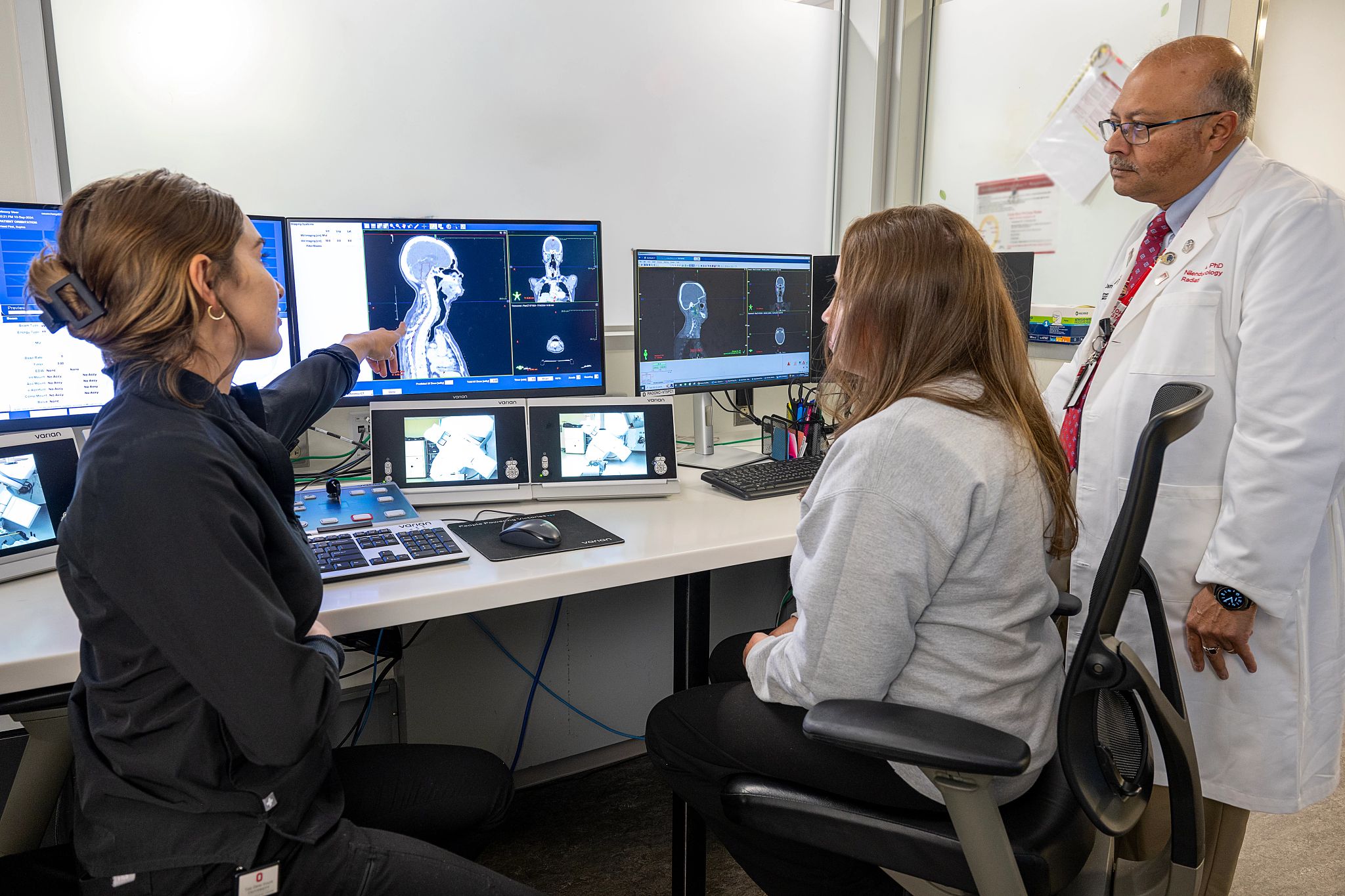 Tessa Rodgers and Sabrina Snyder, Lead Radiation Therapists at The Ohio State University Wexner Medical Center, consult with Nilendu Gupta, PhD, FAAPM, Vice Chair and Chief of Medical Physics at OSUCCC–James.